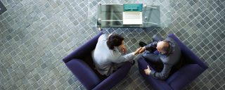 high angle view of two businessmen shaking hands